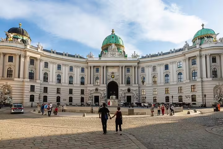 Visitors admire the stunning architecture of the Hofburg Palace in Vienna, a highlight of the Gems and Secrets private tour.