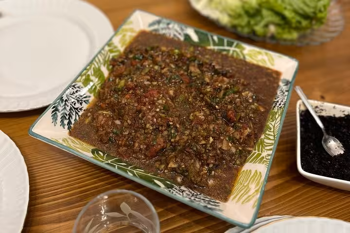 Homemade çiğ köfte mixture on a platter, ready to serve at an at-home Turkish cooking class night