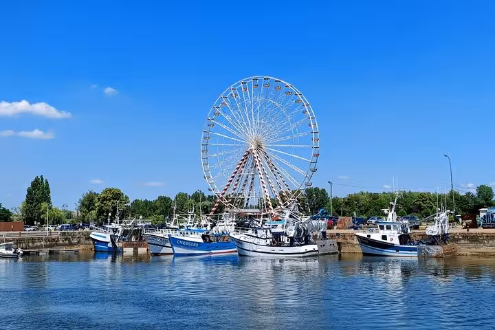 Honfleur harbor ferris wheel and fishing boats view on PEDAL & PORT 2-hour e-bike tour in Normandy