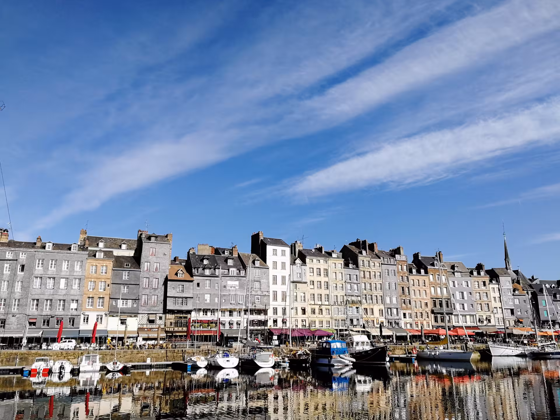 Honfleur Vieux Bassin harbor with colorful waterfront houses and boats, a highlight on a private e-bike tour