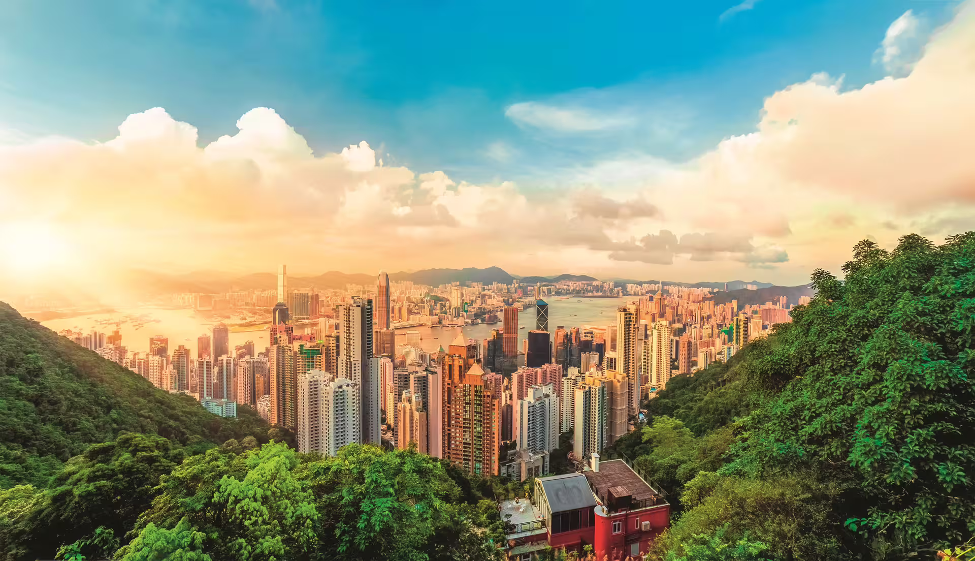 Panoramic view of Hong Kong skyline at sunset from Victoria Peak, a must-see on a private city break tour.