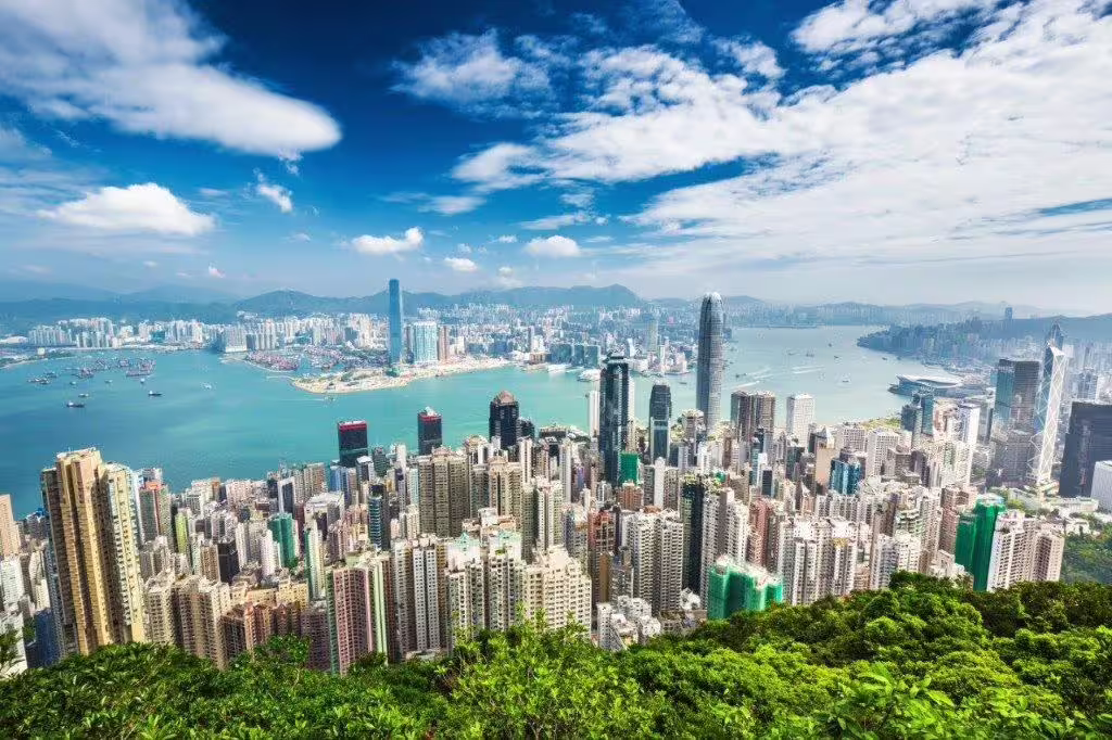 Stunning panoramic view of Hong Kong skyline and Victoria Harbour from Victoria Peak on a clear day.