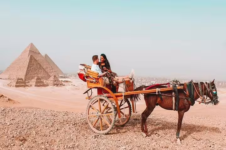 Horse-drawn carriage ride near Giza Pyramids, romantic stop on private 2-day Cairo tour from Cairo