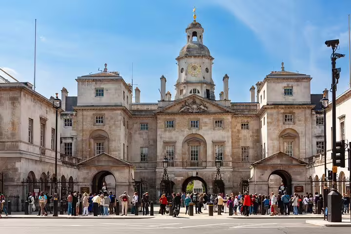 Horse Guards building in London with tourists gathered outside on a sunny day