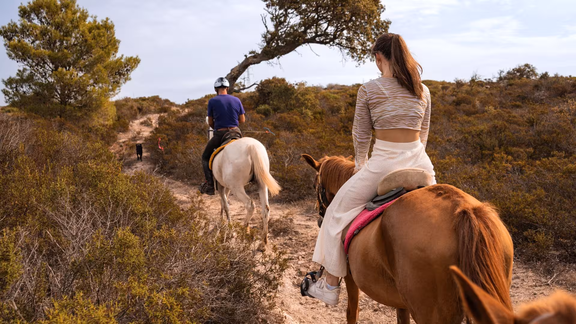 Group horseback riding through Sedini's picturesque landscape, offering a unique adventure near Castelsardo.