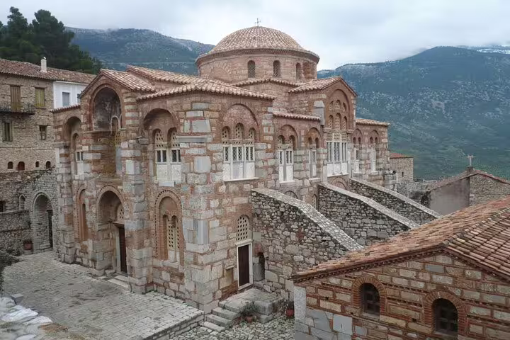 Hosios Loukas Monastery stone church and dome in mountain setting on Delphi private day tour from Athens