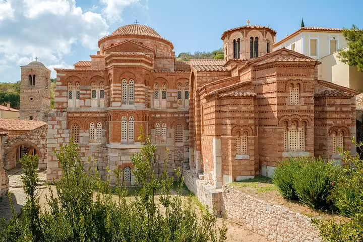 Sunlit Hosios Loukas Monastery Byzantine brick architecture, key stop on Delphi full-day private tour from Athens