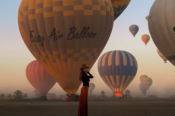 Sunrise hot air balloons launching in Luxor, Egypt, for West Bank flight with hotel pickup and drop-off