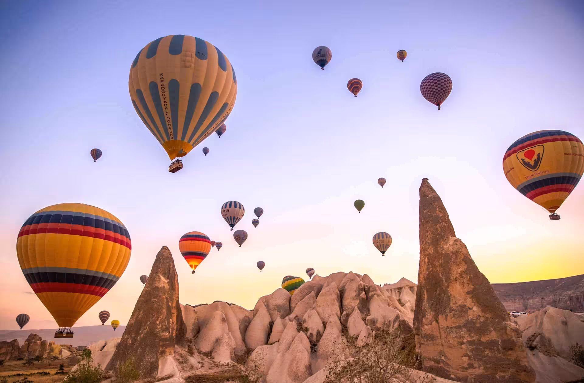 Hot air balloons flying over Cappadocia valleys