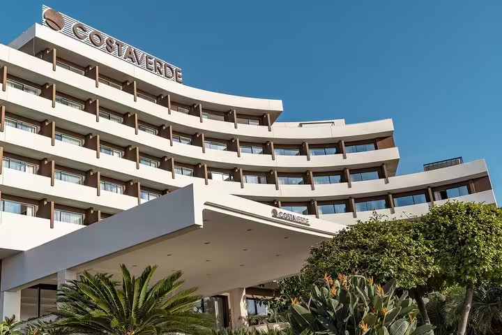Modern Hotel Costa Verde Cefalù facade under clear blue sky, departure point for private transfer to Palermo Airport