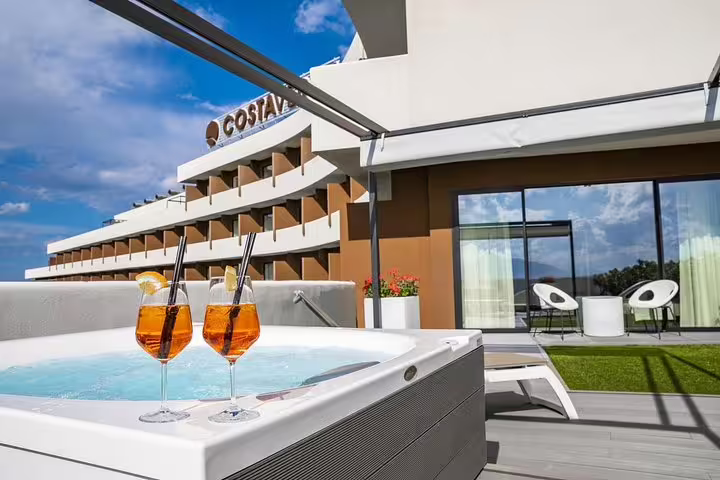 Rooftop jacuzzi with Aperol spritz at Hotel Costa Verde Cefalù, ideal pre-transfer relaxation before Palermo Airport ride