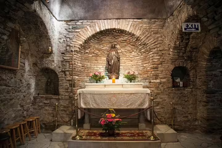 Interior of the House of Virgin Mary in Ephesus featuring a religious statue, part of the private tour from Kusadasi Port.