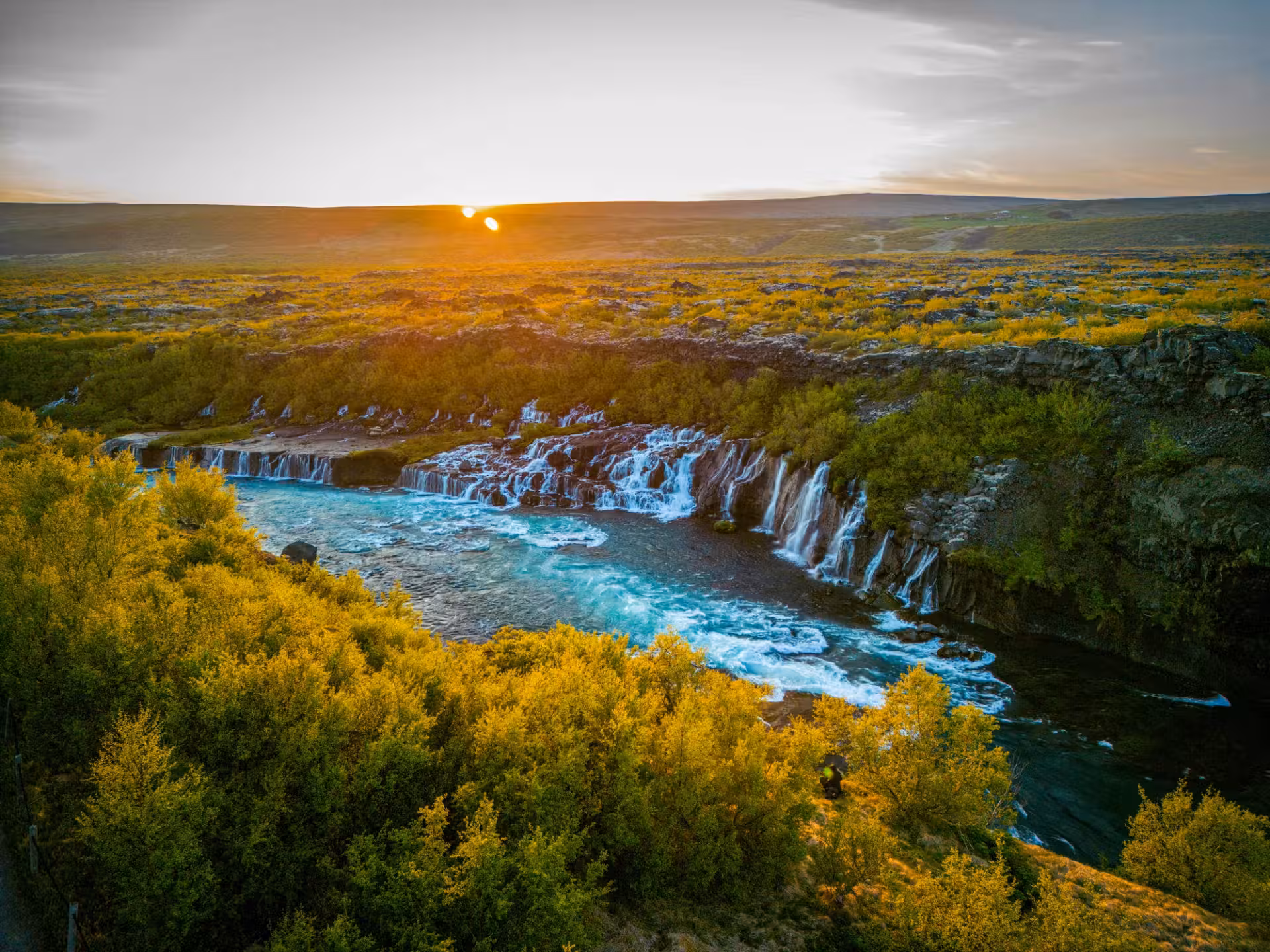 Hraunfossar waterfalls and turquoise river at sunset on Silver Circle Fjord & Fire private tour in Iceland