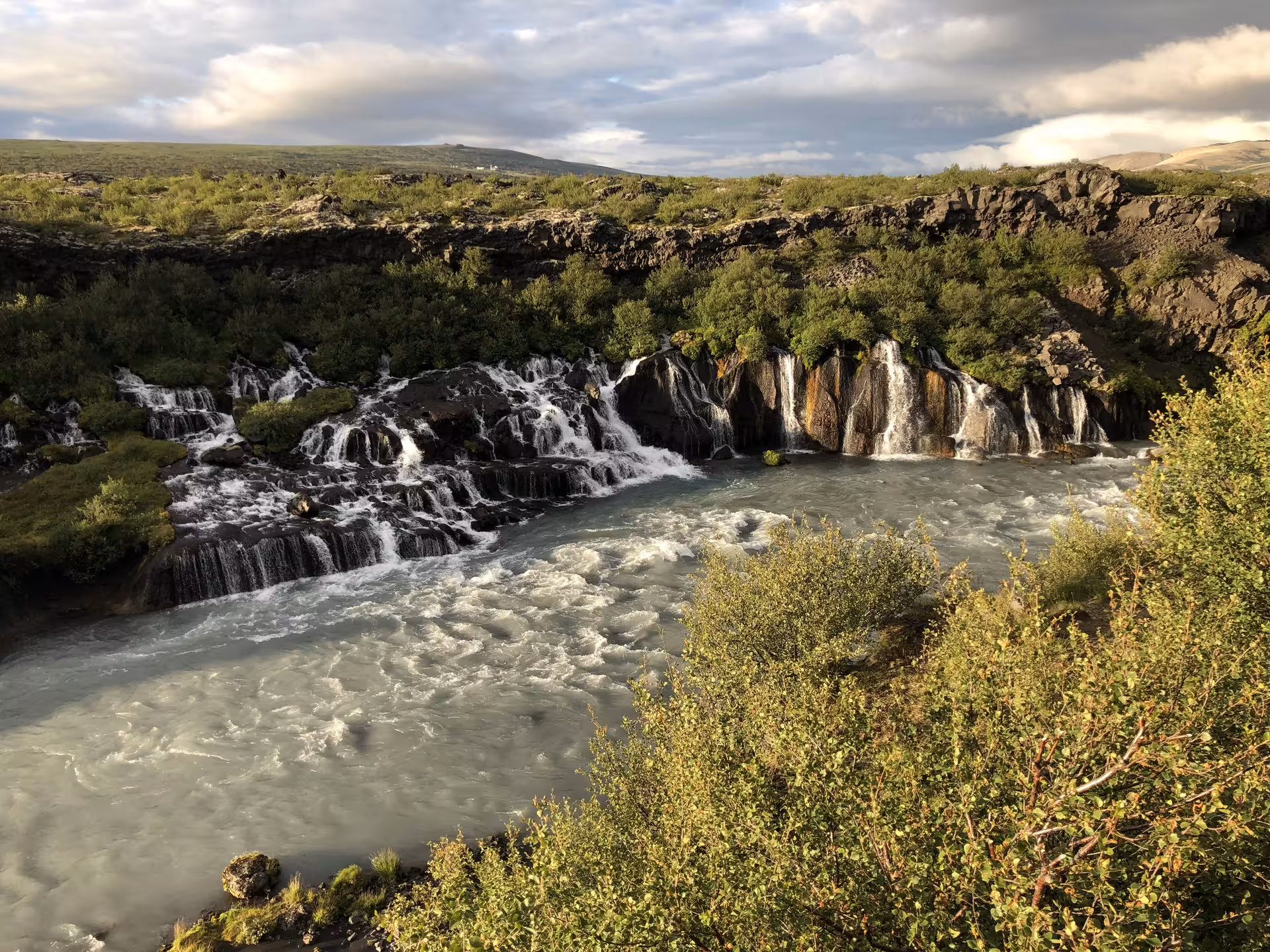 Hraunfossar waterfalls cascading over lava rocks into the Hvítá river in Borgarfjordur, West Iceland