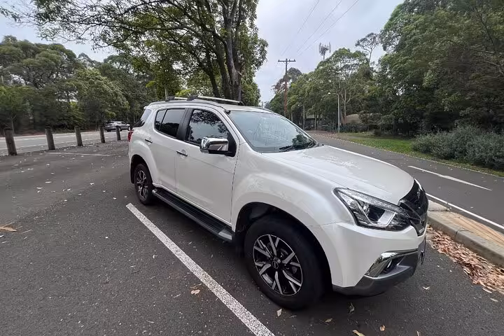 Elegant white SUV parked on a leafy road, ready for premium private tours to Hunter Valley wineries.