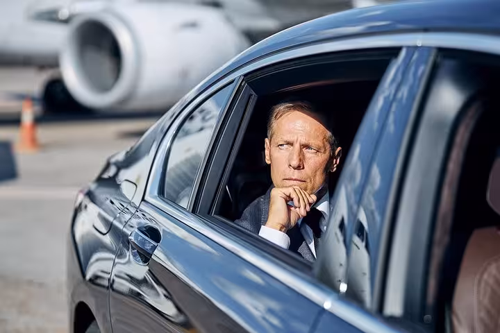 Business traveler in airport car for Hurghada Airport to hotel private transfer with AC meet and greet