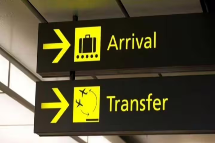 Couple beside private minivan for Hurghada Airport transfer, reliable door-to-door hotel pickup at night