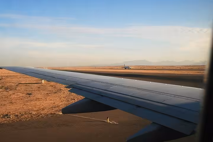 View from airplane wing landing at Hurghada, book AC private transfer from airport to hotel with meet and greet