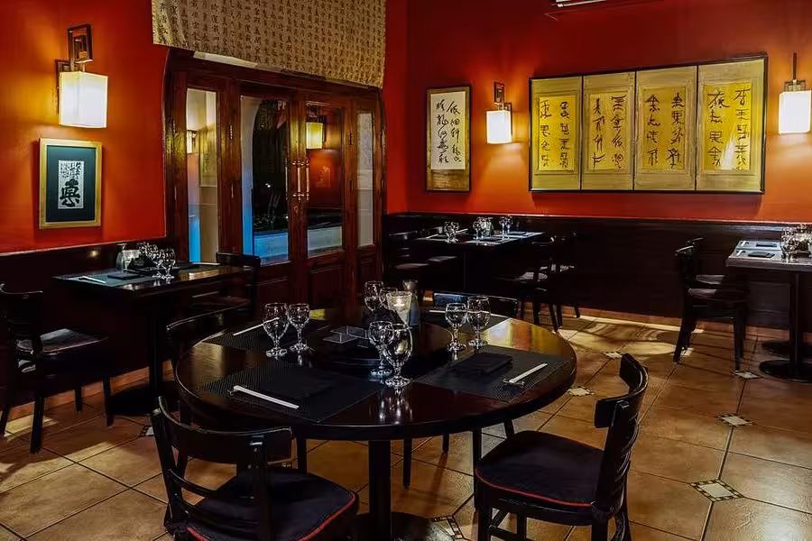 Cozy and elegant Asian-themed restaurant interior in Hurghada, with dim lighting and traditional decor elements.