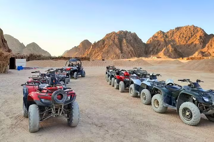 Hurghada desert ATV quad bikes lined up for safari tour with camel ride, dinner and Bedouin show