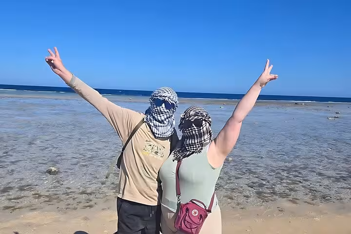 Tour guests posing on Hurghada Red Sea shore after ATV quad or buggy ride, sea and mountain adventure in Egypt