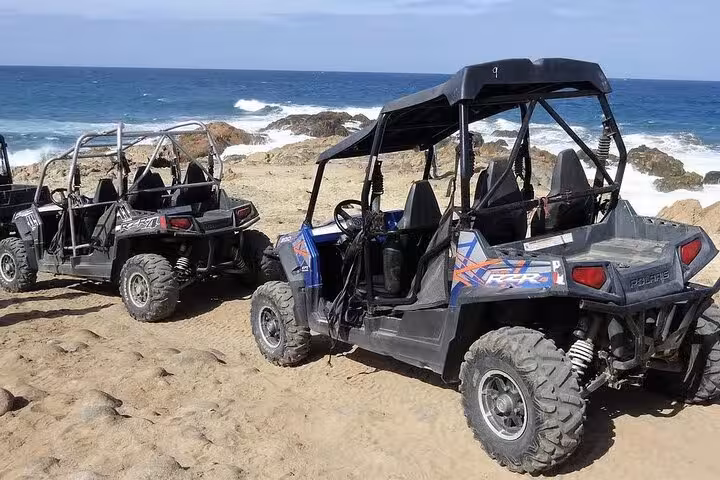 Off-road buggy convoy parked by the Red Sea on Hurghada sea and mountains buggy safari adventure tour