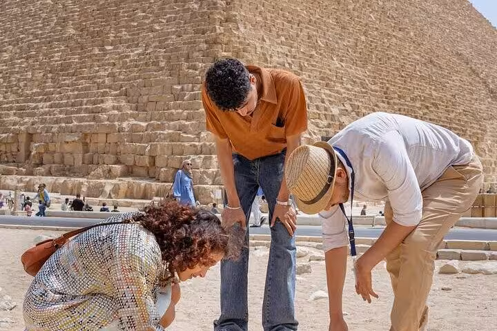 Private guide explains Giza Pyramid stones on Hurghada to Cairo tour with Grand Museum and camel ride