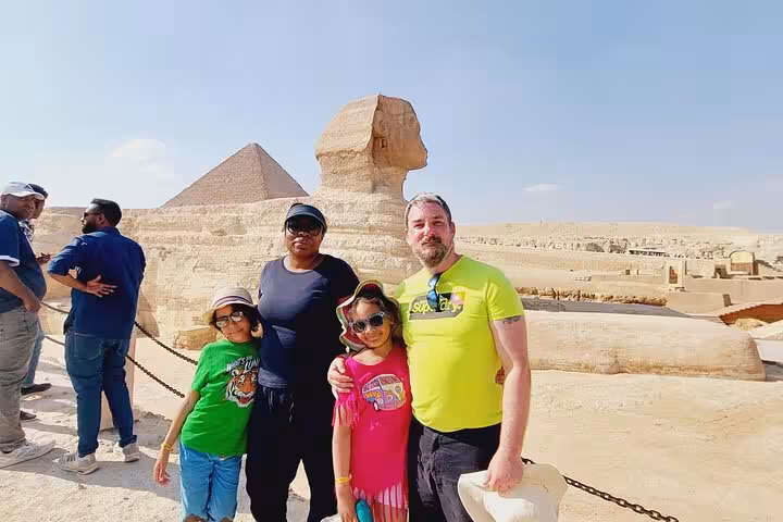 Family at the Sphinx viewpoint with Giza Pyramid backdrop on Hurghada to Cairo tour, Grand Egyptian Museum