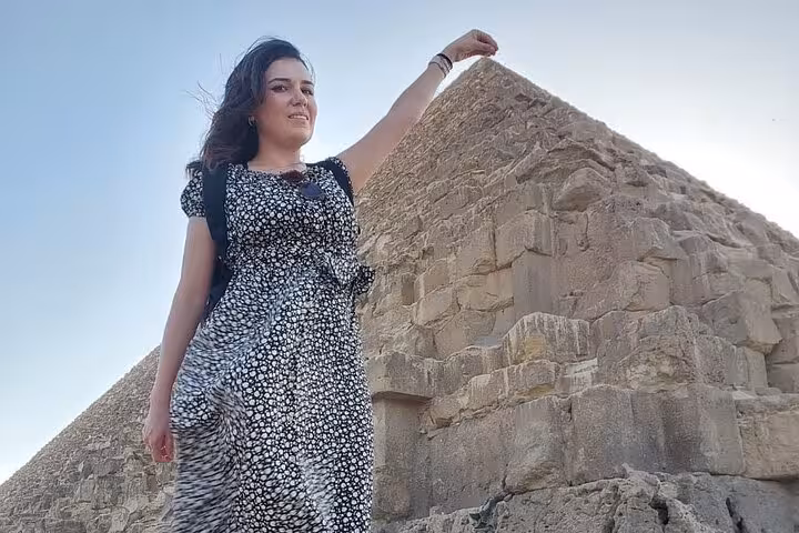 Traveler posing beside the Great Pyramid of Giza on a Hurghada to Cairo day tour with Egypt guide