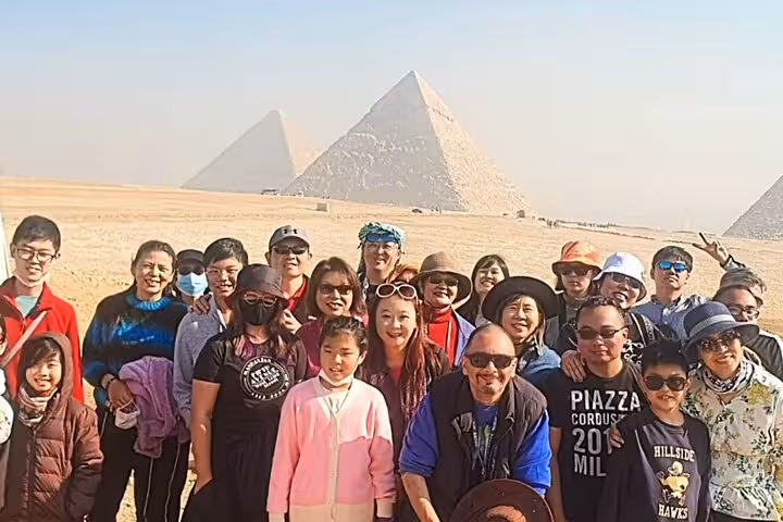 Group photo at Giza Pyramids on full-day tour from Hurghada to Cairo, pyramids and Egyptian Museum