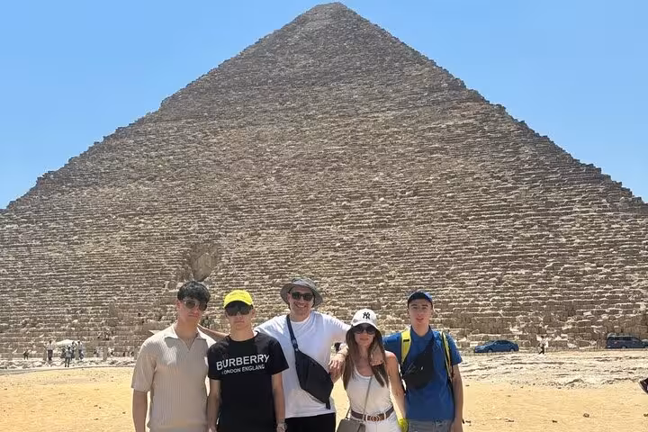 Group photo at Great Pyramid of Giza on Hurghada to Cairo private tour, pyramids and Grand Egyptian Museum visit