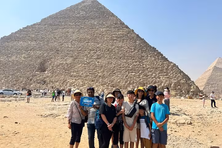 Group photo at Great Pyramid of Giza on private full day Hurghada to Cairo tour with flight