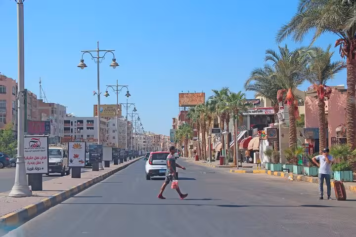 Palm-lined Hurghada street scene on city guided tour, exploring downtown landmarks and local market area
