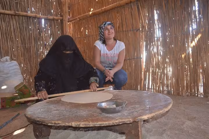 Bedouin woman making flatbread in Hurghada desert camp during quad bike ATV tour with BBQ dinner and pickup