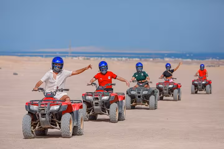 Hurghada desert quad safari group ride by the sea, helmets on, part of dinner show and free shopping tour
