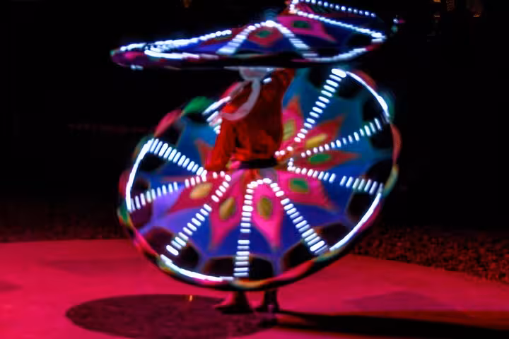 Tanoura LED skirt dancer spinning at Hurghada desert camp night show, part of ATV quad and buggy safari dinner