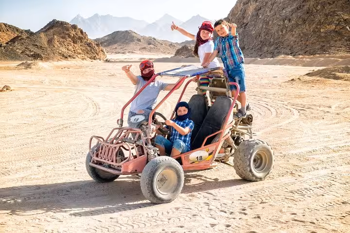 Hurghada dune buggy desert safari with family posing by rocky mountains, ATV and buggy adventure