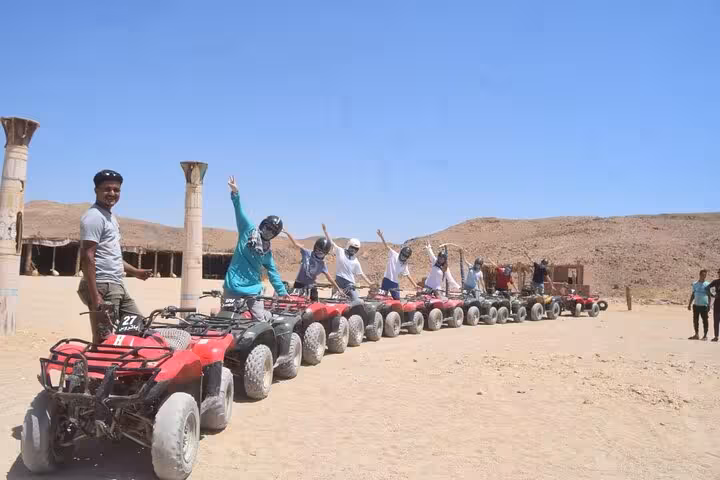 Group quad biking lineup in Hurghada desert camp stop, family safari with 1-hour ride, dinner and show