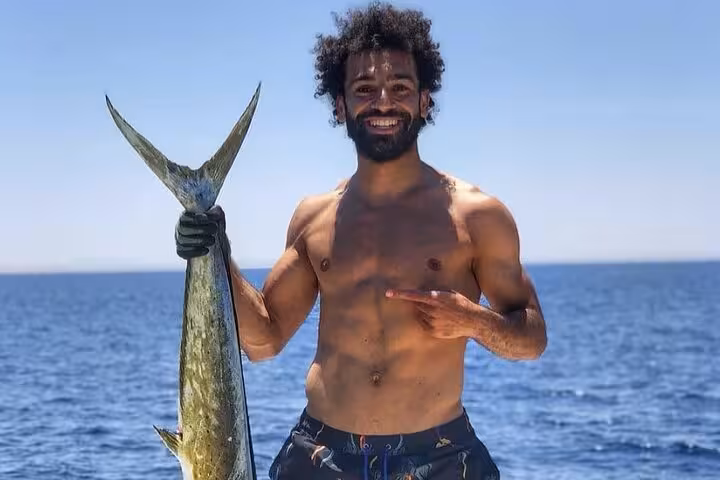 Angler holding a large fish on a private Hurghada Safaga fishing and snorkeling tour in the Red Sea