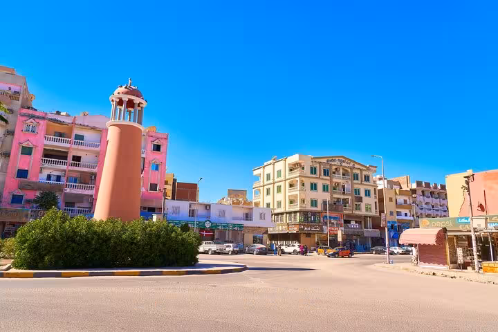 Hurghada city guided tour view of a roundabout and landmark tower near local market streets in Egypt