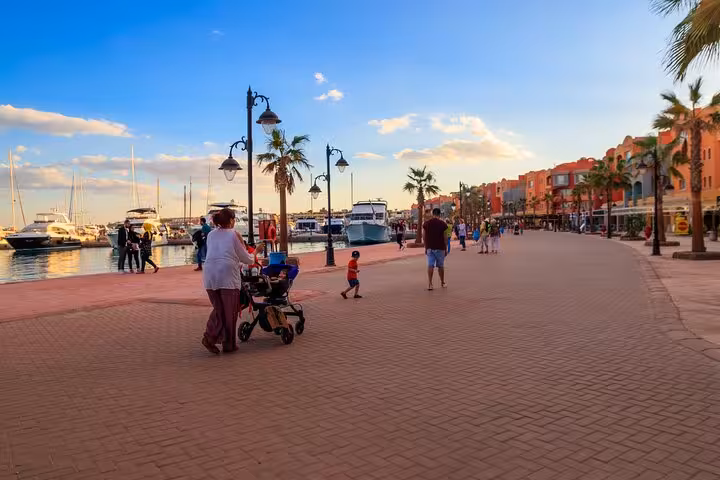 Hurghada city guided tour along Marina Boulevard, palm-lined promenade with yachts and sunset views