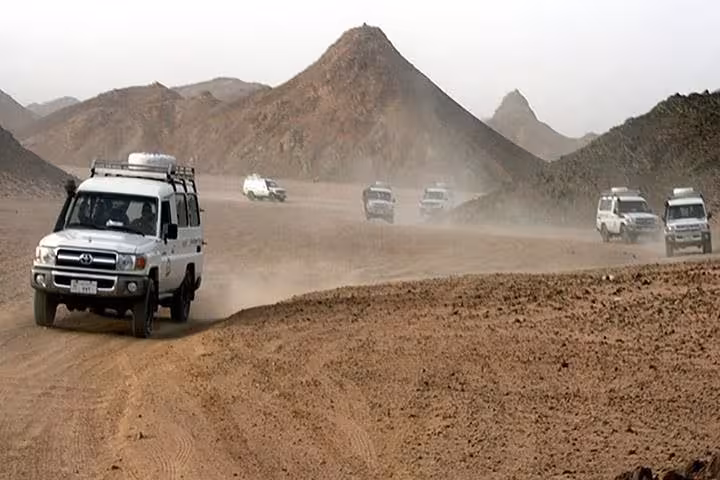Convoy of 4x4 jeeps racing through Hurghada desert mountains on a 6-hour safari adventure tour