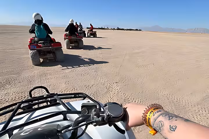 ATV quad biking across Hurghada desert dunes on a 6-hour jeep safari with BBQ dinner and show