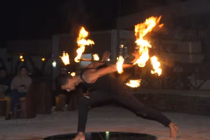 Fire dancer performing at Bedouin village dinner show on Hurghada Jeep Super Safari desert tour