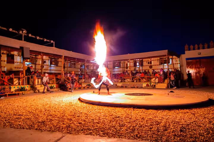 Fire show performance at Bedouin camp during Hurghada Jeep Super Safari with dinner and desert entertainment