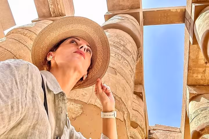 Traveler admiring Karnak Temple columns in Luxor on Hurghada day trip to Valley of the Kings and Tutankhamun