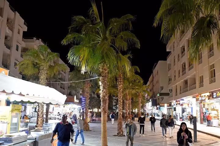 Hurghada night market street with palm trees and local shops, ideal shopping stop on a private city tour