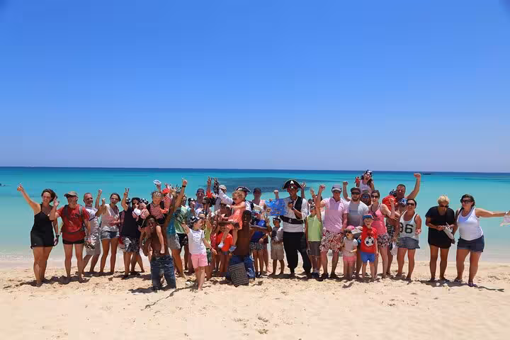 Group photo on Orange Bay beach during Hurghada Pirates sailing boat trip with buffet lunch and sea views