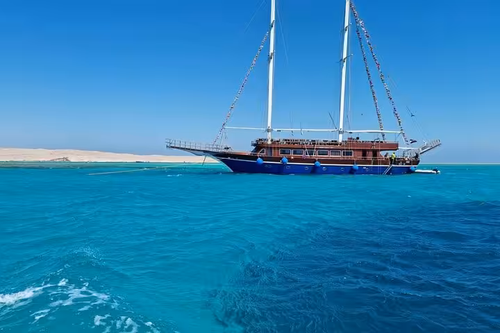 Hurghada pirates-style sailing boat anchored in crystal Red Sea near Orange Bay, ideal for snorkeling and lunch