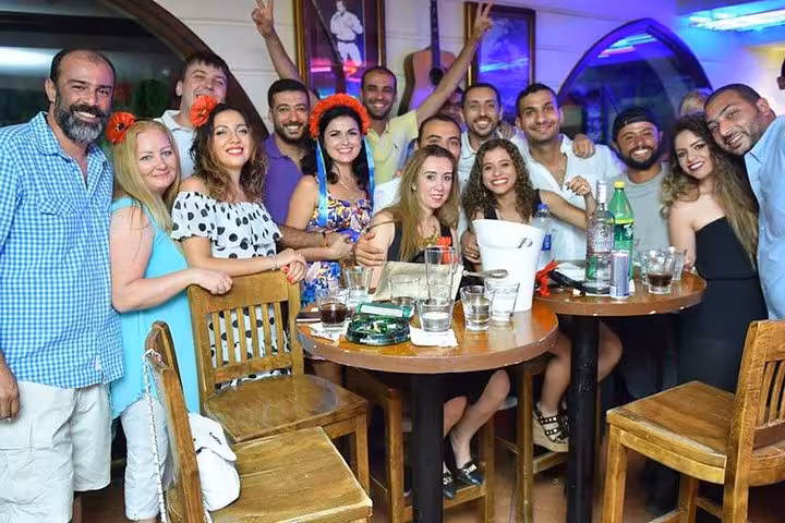 Tourists enjoying Hurghada nightlife at a lively bar on a private night tour with guide and hotel pickup